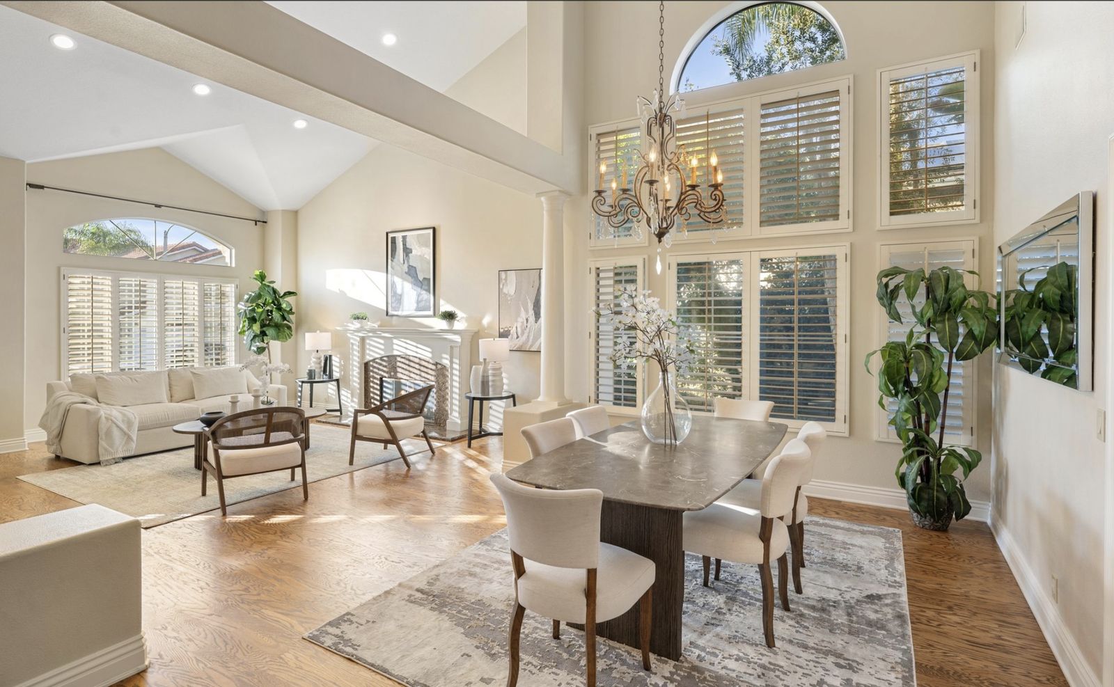 Bright living and dining room with tall, spotless windows